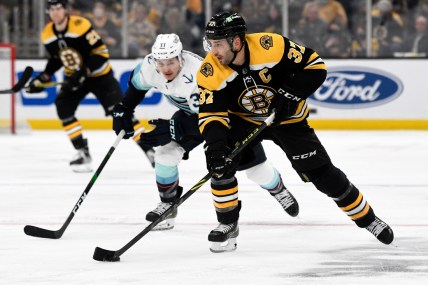 Feb 1, 2022; Boston, Massachusetts, USA; Boston Bruins center Patrice Bergeron (37) skates with the puck in front of Seattle Kraken center Yanni Gourde (37) during the first period at the TD Garden. Mandatory Credit: Brian Fluharty-USA TODAY Sports