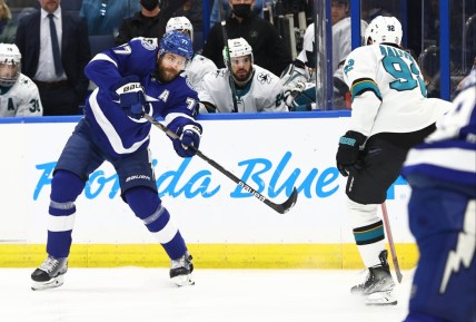 Feb 1, 2022; Tampa, Florida, USA; Tampa Bay Lightning defenseman Victor Hedman (77) shoots s San Jose Sharks left wing Rudolfs Balcers (92) defends during the first period at Amalie Arena. Mandatory Credit: Kim Klement-USA TODAY Sports