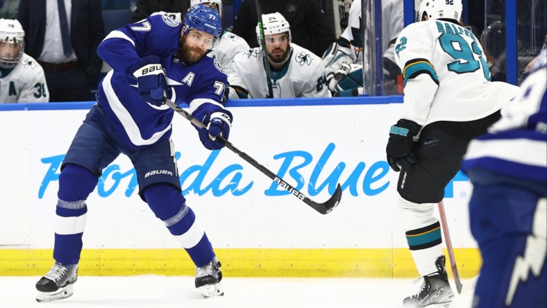 Feb 1, 2022; Tampa, Florida, USA; Tampa Bay Lightning defenseman Victor Hedman (77) shoots s San Jose Sharks left wing Rudolfs Balcers (92) defends during the first period at Amalie Arena. Mandatory Credit: Kim Klement-USA TODAY Sports