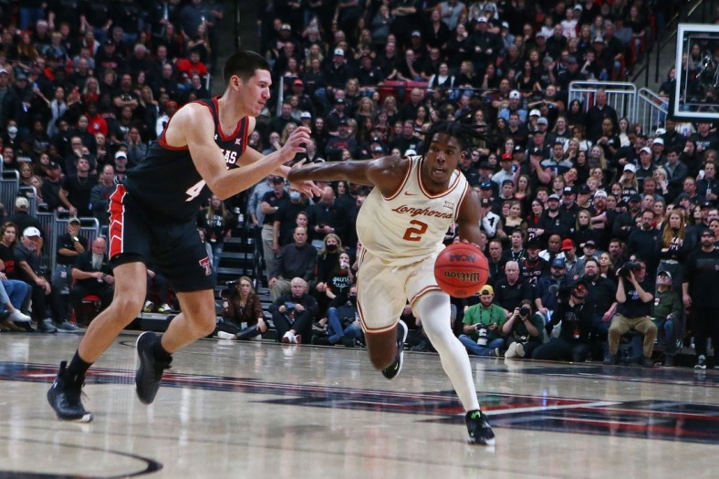 Feb 1, 2022; Lubbock, Texas, USA;  Texas Longhorns guard Marcus Carr (2) dribbles the ball against Texas Tech Red Raiders forward Daniel Batcho (4) in the second half at United Supermarkets Arena. Mandatory Credit: Michael C. Johnson-USA TODAY Sports