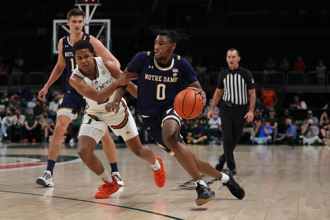 Feb 2, 2022; Coral Gables, Florida, USA; Notre Dame Fighting Irish guard Blake Wesley (0) drives the ball around Miami Hurricanes guard Charlie Moore (3) during the first half at Watsco Center. Mandatory Credit: Jasen Vinlove-USA TODAY Sports