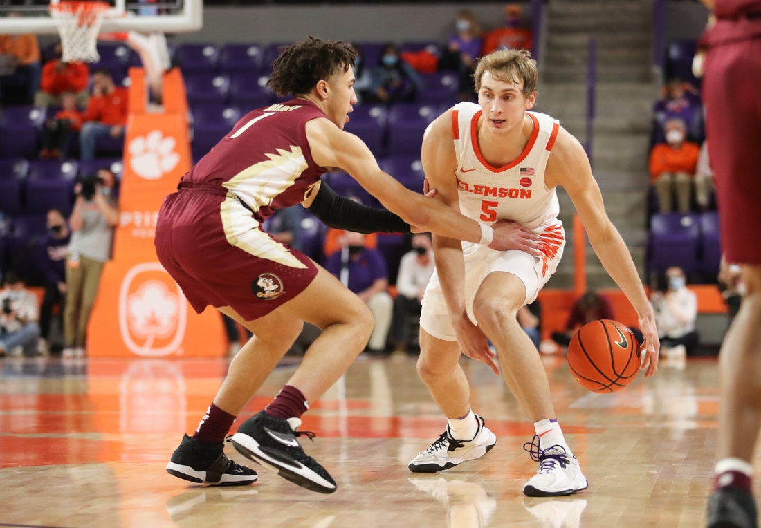 Feb 2, 2022; Clemson, South Carolina, USA; Clemson Tigers forward Hunter Tyson (5) dribbles the ball as Florida State Seminoles guard Jalen Warley (1) defends during the first half at Littlejohn Coliseum. Mandatory Credit: Dawson Powers-USA TODAY Sports