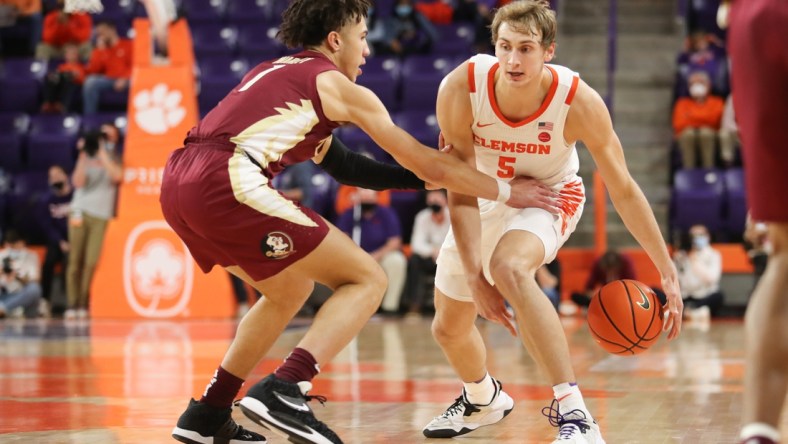 Feb 2, 2022; Clemson, South Carolina, USA; Clemson Tigers forward Hunter Tyson (5) dribbles the ball as Florida State Seminoles guard Jalen Warley (1) defends during the first half at Littlejohn Coliseum. Mandatory Credit: Dawson Powers-USA TODAY Sports