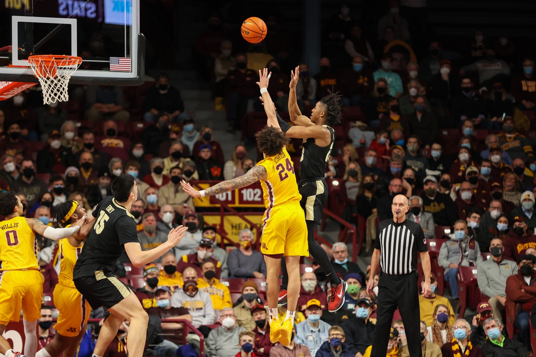 Feb 2, 2022; Minneapolis, Minnesota, USA; Purdue Boilermakers guard Jaden Ivey (23) shoots the ball against Minnesota Gophers guard Sean Sutherlin (24) during the first half at Williams Arena. Mandatory Credit: Matt Krohn-USA TODAY Sports