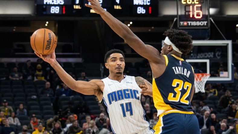 Feb 2, 2022; Indianapolis, Indiana, USA; Orlando Magic guard Gary Harris (14) passes the ball while Indiana Pacers guard Terry Taylor (32) defends  in the second half at Gainbridge Fieldhouse. Mandatory Credit: Trevor Ruszkowski-USA TODAY Sports