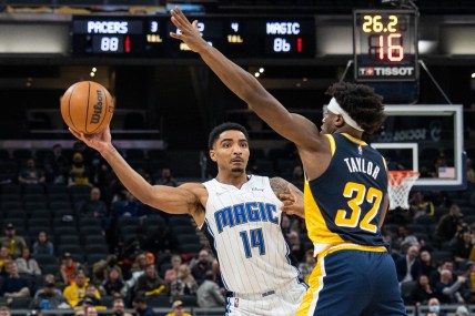 Feb 2, 2022; Indianapolis, Indiana, USA; Orlando Magic guard Gary Harris (14) passes the ball while Indiana Pacers guard Terry Taylor (32) defends  in the second half at Gainbridge Fieldhouse. Mandatory Credit: Trevor Ruszkowski-USA TODAY Sports