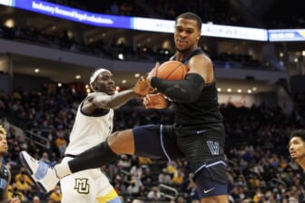 Feb 2, 2022; Milwaukee, Wisconsin, USA;  Villanova Wildcats forward Eric Dixon (43) grabs a rebound in front of Marquette Golden Eagles forward Kur Kuath (35) during the second half at Fiserv Forum. Mandatory Credit: Jeff Hanisch-USA TODAY Sports