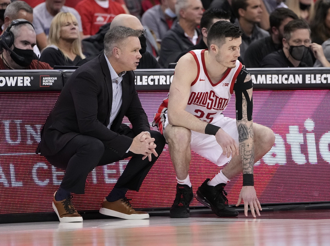 Ohio State Buckeyes head coach Chris Holtmann talks to forward Kyle Young (25) as he prepares to enter the game during the second half of the NCAA men's basketball game against the Towson Tigers at Value City Arena in Columbus on Wednesday, Dec. 8, 2021.

Holtmann Young