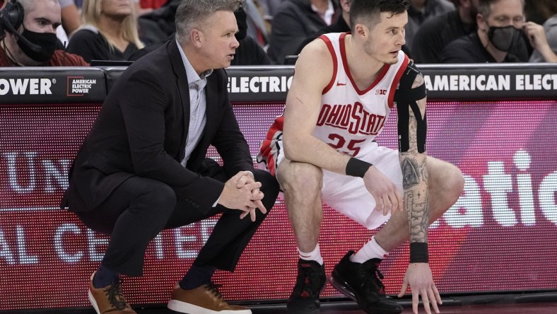 Ohio State Buckeyes head coach Chris Holtmann talks to forward Kyle Young (25) as he prepares to enter the game during the second half of the NCAA men's basketball game against the Towson Tigers at Value City Arena in Columbus on Wednesday, Dec. 8, 2021.

Holtmann Young