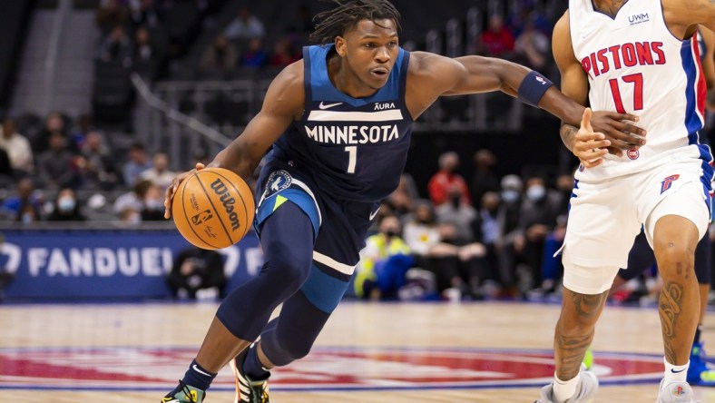 Feb 3, 2022; Detroit, Michigan, USA; Minnesota Timberwolves forward Anthony Edwards (1) drives to the basket against Detroit Pistons guard Rodney McGruder (17) during the first quarter at Little Caesars Arena. Mandatory Credit: Raj Mehta-USA TODAY Sports