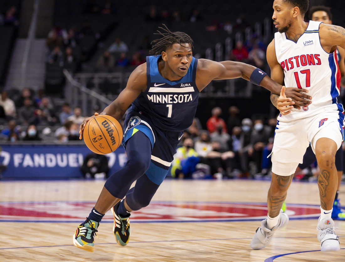 Feb 3, 2022; Detroit, Michigan, USA; Minnesota Timberwolves forward Anthony Edwards (1) drives to the basket against Detroit Pistons guard Rodney McGruder (17) during the first quarter at Little Caesars Arena. Mandatory Credit: Raj Mehta-USA TODAY Sports