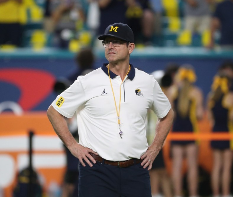 Michigan coach Jim Harbaugh watched his team warm up before the Orange Bowl against Georgia on Friday, Dec. 31, 2021, in Miami Gardens, Florida.Capital One Orange Bowl