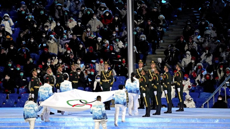 Feb 4, 2022; Beijing, CHINA;  The Olympic flag is raised during the Opening Ceremony of the Beijing 2022 Winter Olympic Games at Beijing National Stadium.  Mandatory Credit: Harrison Hill-USA TODAY Sports