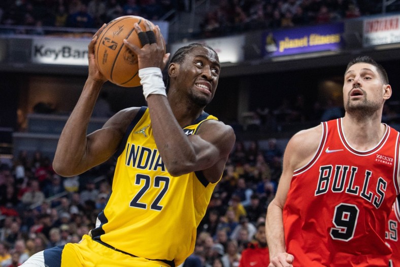 Feb 4, 2022; Indianapolis, Indiana, USA; Indiana Pacers guard Caris LeVert (22) shoots the ball while Chicago Bulls center Nikola Vucevic (9) defends in the first half at Gainbridge Fieldhouse. Mandatory Credit: Trevor Ruszkowski-USA TODAY Sports