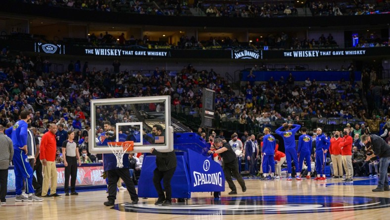 Feb 4, 2022; Dallas, Texas, USA; The American Airlines Center arena crew roll out a secondary backup backboard during the first quarter of the game between the Dallas Mavericks and the Philadelphia 76ers at the American Airlines Center. Mandatory Credit: Jerome Miron-USA TODAY Sports