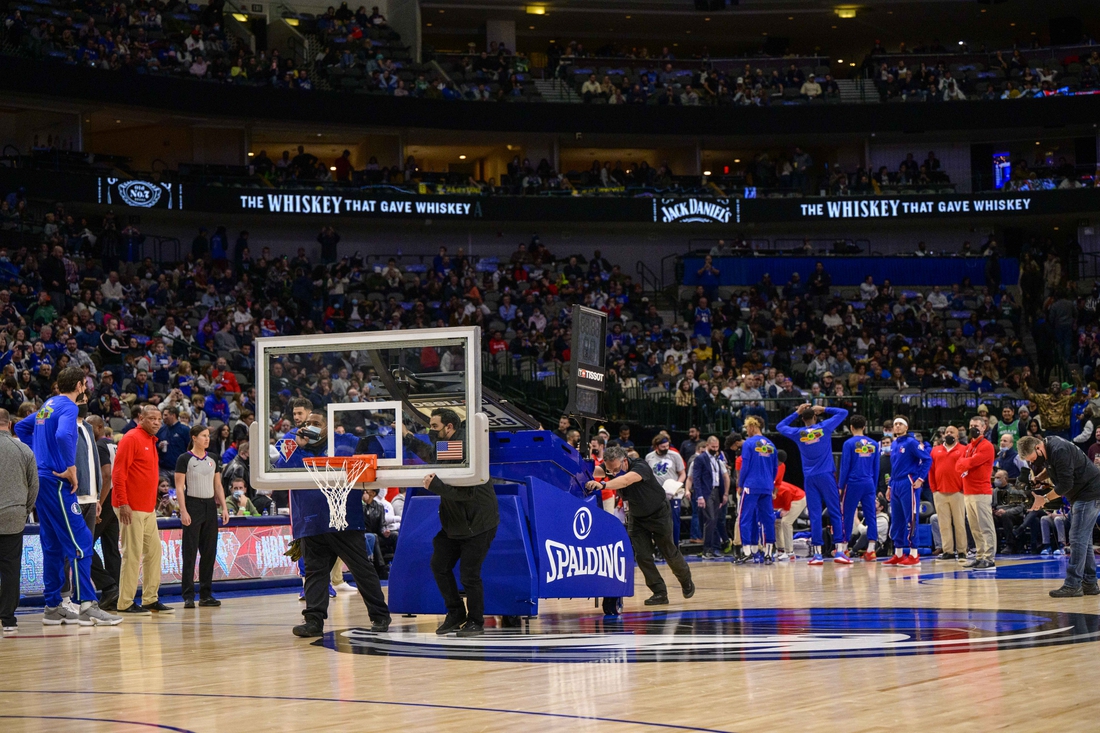 Feb 4, 2022; Dallas, Texas, USA; The American Airlines Center arena crew roll out a secondary backup backboard during the first quarter of the game between the Dallas Mavericks and the Philadelphia 76ers at the American Airlines Center. Mandatory Credit: Jerome Miron-USA TODAY Sports