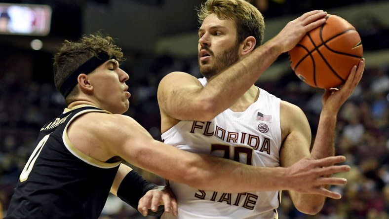 Feb 5, 2022; Tallahassee, Florida, USA; Florida State Seminoles forward Harrison Prieto (30) protects the ball from Wake Forest Deamon Deacons forward Jake Laravia (0) during the game at Donald L. Tucker Center. Mandatory Credit: Melina Myers-USA TODAY Sports