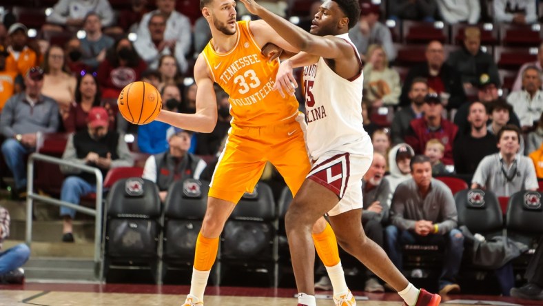 Feb 5, 2022; Columbia, South Carolina, USA; Tennessee Volunteers forward Uros Plavsic (33) passes around South Carolina Gamecocks forward Wildens Leveque (15) in the second half at Colonial Life Arena. Mandatory Credit: Jeff Blake-USA TODAY Sports