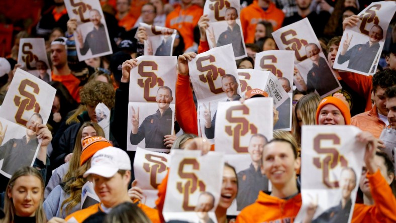 Oklahoma State fans hold up newspapers with a picture of former OU football coach Lincoln Riley during Oklahoma's introduction before a Bedlam basketball game between the University of Oklahoma Sooners (OU) and the Oklahoma State University Cowboys (OSU) at Gallagher-Iba Arena in Stillwater, Saturday, Feb. 5, 2022.

Bedlam Basketball