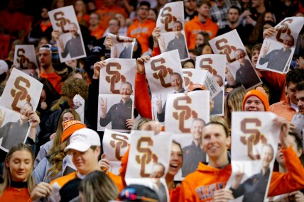 Oklahoma State fans hold up newspapers with a picture of former OU football coach Lincoln Riley during Oklahoma's introduction before a Bedlam basketball game between the University of Oklahoma Sooners (OU) and the Oklahoma State University Cowboys (OSU) at Gallagher-Iba Arena in Stillwater, Saturday, Feb. 5, 2022.

Bedlam Basketball