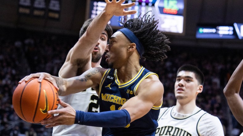 Feb 5, 2022; West Lafayette, Indiana, USA;  Michigan Wolverines guard Frankie Collins (10) passes the ball while Purdue Boilermakers guard Ethan Morton (25) defends in the first half at Mackey Arena. Mandatory Credit: Trevor Ruszkowski-USA TODAY Sports