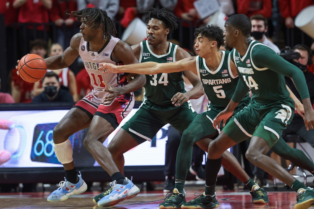 Feb 5, 2022; Piscataway, New Jersey, USA; Rutgers Scarlet Knights center Clifford Omoruyi (11) dribbles as Michigan State Spartans forward Julius Marble II (34) and guard Max Christie (5) and forward Gabe Brown (44) defend during the first half at Jersey Mike's Arena. Mandatory Credit: Vincent Carchietta-USA TODAY Sports