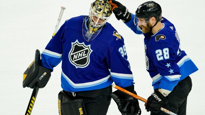 Feb 5, 2022; Las Vegas, Nevada, USA; Metropolitan Division goalie Tristan Jarry (35) of the Pittsburgh Penguins reacts with Metropolitan Division forward Claude Giroux (28) of the Philadelphia Flyers during the 2022 NHL All-Star Game at T-Mobile Arena. Mandatory Credit: Lucas Peltier-USA TODAY Sports