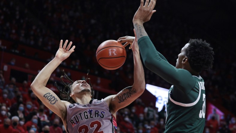 Feb 5, 2022; Piscataway, New Jersey, USA; Michigan State Spartans forward Marcus Bingham Jr. (30) blocks a shot by Rutgers Scarlet Knights guard Caleb McConnell (22) during the second half at Jersey Mike's Arena. Mandatory Credit: Vincent Carchietta-USA TODAY Sports