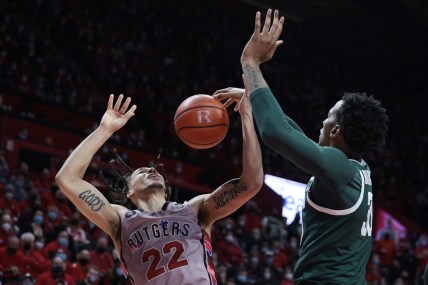 Feb 5, 2022; Piscataway, New Jersey, USA; Michigan State Spartans forward Marcus Bingham Jr. (30) blocks a shot by Rutgers Scarlet Knights guard Caleb McConnell (22) during the second half at Jersey Mike's Arena. Mandatory Credit: Vincent Carchietta-USA TODAY Sports