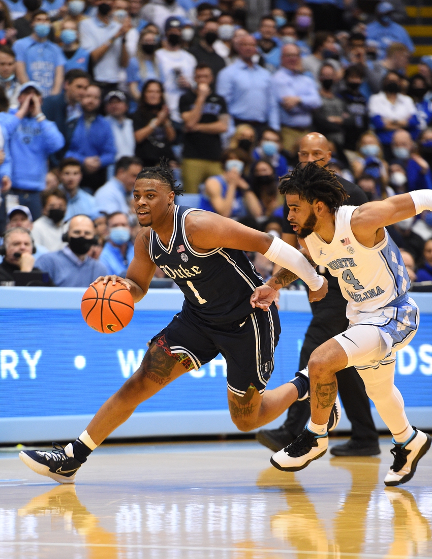 Feb 5, 2022; Chapel Hill, North Carolina, USA;  Duke Blue Devils guard Trevor Keels (1) dribbles as North Carolina Tar Heels guard R.J. Davis (4) defends in the first half at Dean E. Smith Center. Mandatory Credit: Bob Donnan-USA TODAY Sports