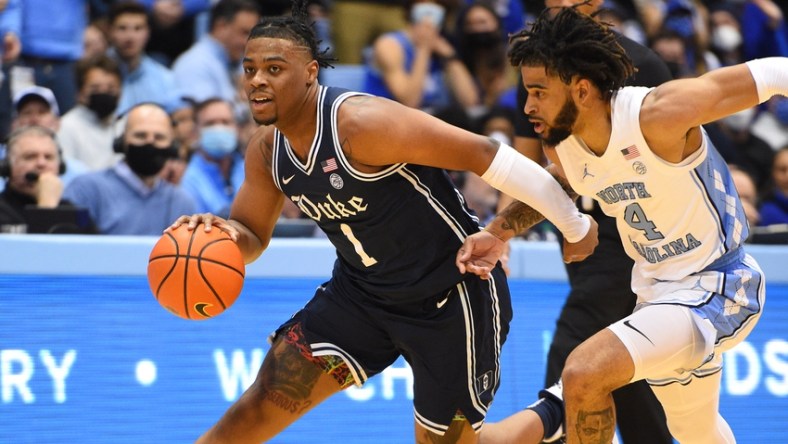 Feb 5, 2022; Chapel Hill, North Carolina, USA;  Duke Blue Devils guard Trevor Keels (1) dribbles as North Carolina Tar Heels guard R.J. Davis (4) defends in the first half at Dean E. Smith Center. Mandatory Credit: Bob Donnan-USA TODAY Sports