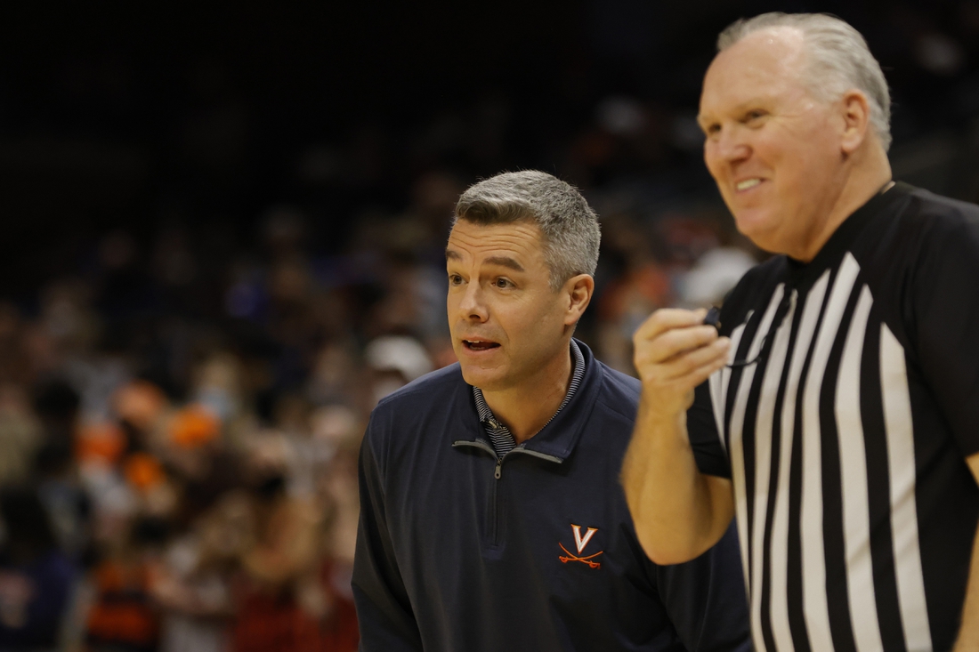 Feb 5, 2022; Charlottesville, Virginia, USA; Virginia Cavaliers head coach Tony Bennett (L) jokes with referee Jamie Luckie (R) against the Miami Hurricanes during the first half at John Paul Jones Arena. Mandatory Credit: Geoff Burke-USA TODAY Sports