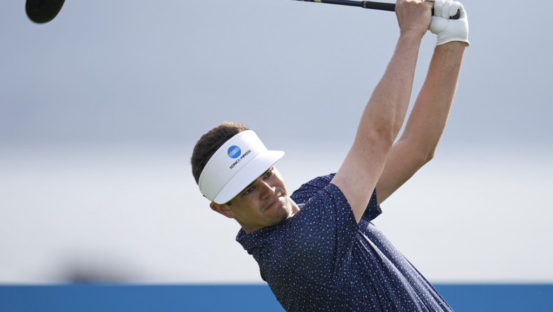 Feb 5, 2022; Pebble Beach, California, USA; Beau Hossler plays his shot on the 18th tee during the third round of the AT&T Pebble Beach Pro-Am golf tournament at Pebble Beach Golf Links. Mandatory Credit: Ray Acevedo-USA TODAY Sports