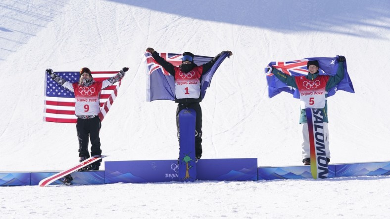 Feb 6, 2022; Zhangjiakou, China; Silver medalist Julia Marino (USA), left, gold medalist Zoi Sadowski Synnott (NZL), center, and bronze medalist Tess Coady (AUS) celebrate in the women's slopestyle snowboarding final during the Beijing 2022 Olympic Winter Games at Genting Snow Park. Mandatory Credit: Jack Gruber-USA TODAY Sports