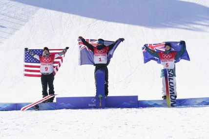 Feb 6, 2022; Zhangjiakou, China; Silver medalist Julia Marino (USA), left, gold medalist Zoi Sadowski Synnott (NZL), center, and bronze medalist Tess Coady (AUS) celebrate in the women's slopestyle snowboarding final during the Beijing 2022 Olympic Winter Games at Genting Snow Park. Mandatory Credit: Jack Gruber-USA TODAY Sports