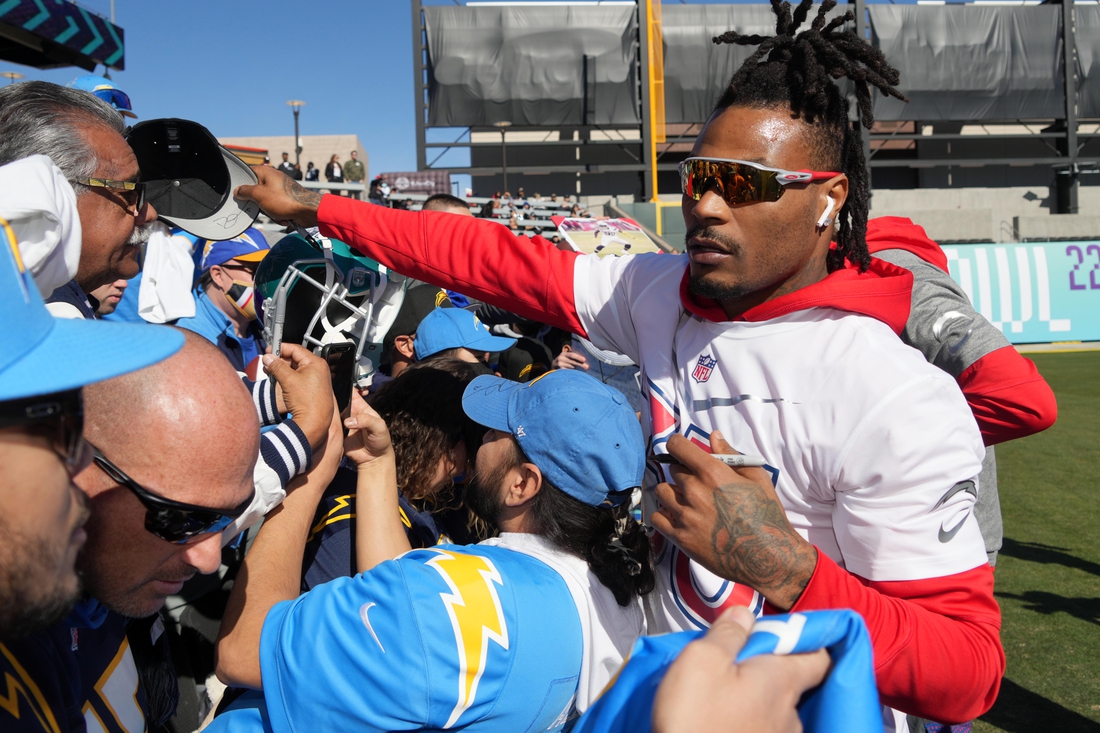 Feb 5, 2022; Las Vegas, NV, USA; Los Angeles Chargers safety Derwin James signs autographs during AFC practice at the Las Vegas Ballpark. Mandatory Credit: Kirby Lee-USA TODAY Sports