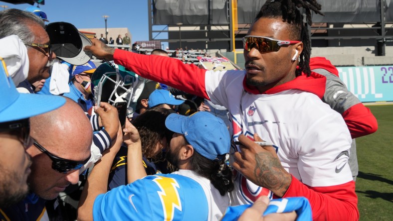 Feb 5, 2022; Las Vegas, NV, USA; Los Angeles Chargers safety Derwin James signs autographs during AFC practice at the Las Vegas Ballpark. Mandatory Credit: Kirby Lee-USA TODAY Sports