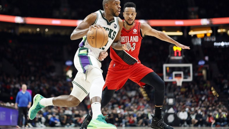 Feb 5, 2022; Portland, Oregon, USA; Milwaukee Bucks small forward Khris Middleton (22) dribbles the ball against Portland Trail Blazers shooting guard CJ McCollum (3) during the first half at Moda Center. Mandatory Credit: Soobum Im-USA TODAY Sports