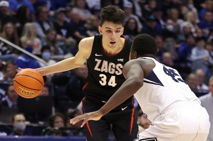 Feb 5, 2022; Provo, Utah, USA; Gonzaga Bulldogs center Chet Holmgren (34) drives the ball against Brigham Young Cougars forward Fousseyni Traore (45) in the first half at Marriott Center. Mandatory Credit: Rob Gray-USA TODAY Sports
