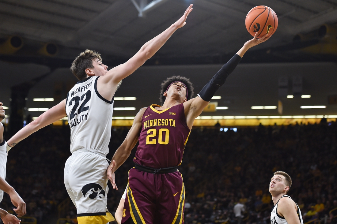 Feb 6, 2022; Iowa City, Iowa, USA; Minnesota Golden Gophers guard E.J. Stephens (20) shoots the ball as Iowa Hawkeyes forward Patrick McCaffery (22) defends during the first half at Carver-Hawkeye Arena. Mandatory Credit: Jeffrey Becker-USA TODAY Sports