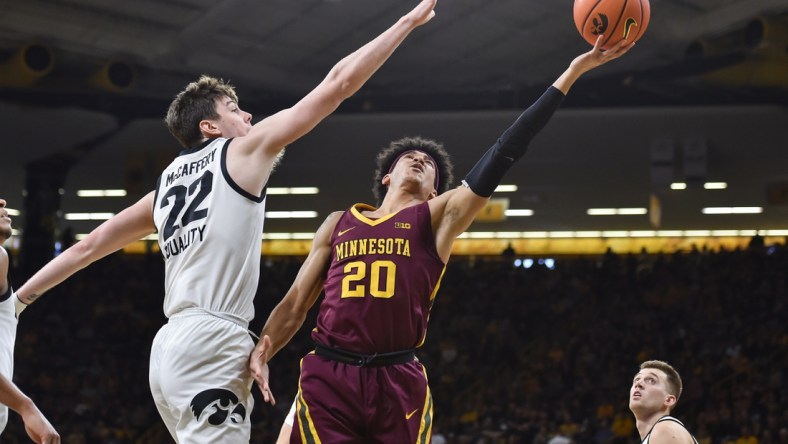 Feb 6, 2022; Iowa City, Iowa, USA; Minnesota Golden Gophers guard E.J. Stephens (20) shoots the ball as Iowa Hawkeyes forward Patrick McCaffery (22) defends during the first half at Carver-Hawkeye Arena. Mandatory Credit: Jeffrey Becker-USA TODAY Sports