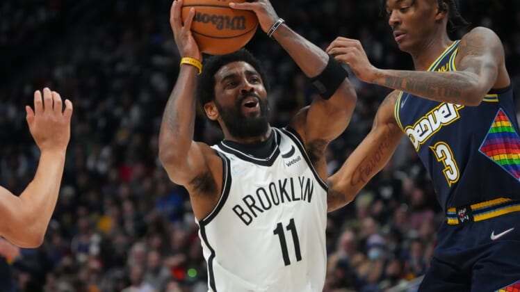 Feb 6, 2022; Denver, Colorado, USA; Brooklyn Nets guard Kyrie Irving (11) drives at Denver Nuggets guard Bones Hyland (3) in the second half at Ball Arena. Mandatory Credit: Ron Chenoy-USA TODAY Sports