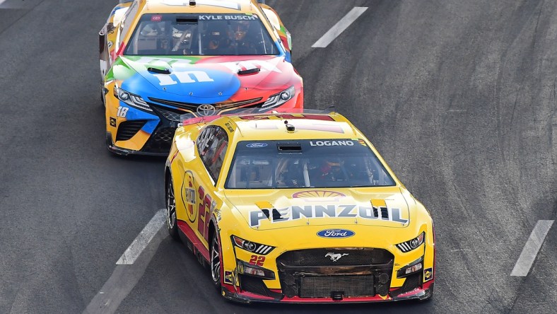 Feb 6, 2022; Los Angeles, California, USA; NASCAR Series Cup driver Joey Logano (22) and Kyle Busch (18) race for position during the Busch Light Clash at The Coliseum at Los Angeles Memorial Coliseum. Mandatory Credit: Gary A. Vasquez-USA TODAY Sports