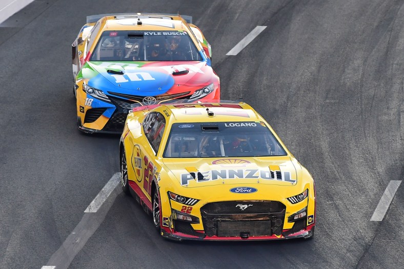 Feb 6, 2022; Los Angeles, California, USA; NASCAR Series Cup driver Joey Logano (22) and Kyle Busch (18) race for position during the Busch Light Clash at The Coliseum at Los Angeles Memorial Coliseum. Mandatory Credit: Gary A. Vasquez-USA TODAY Sports