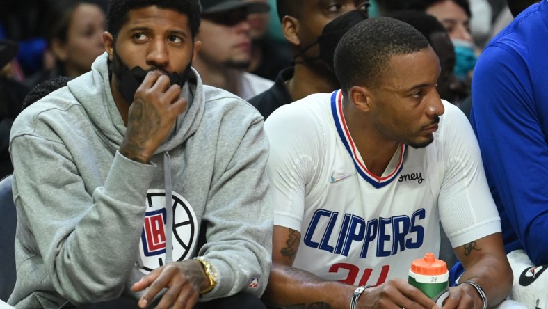 Feb 6, 2022; Los Angeles, California, USA;    Los Angeles Clippers guard Paul George (13) sits on the bench next to Los Angeles Clippers forward Norman Powell (24) in the second half against the Milwaukee Bucks at Crypto.com Arena. Mandatory Credit: Jayne Kamin-Oncea-USA TODAY Sports