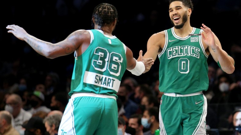 Feb 8, 2022; Brooklyn, New York, USA; Boston Celtics forward Jayson Tatum (0) high fives guard Marcus Smart (36) during the first quarter against the Brooklyn Nets at Barclays Center. Mandatory Credit: Brad Penner-USA TODAY Sports