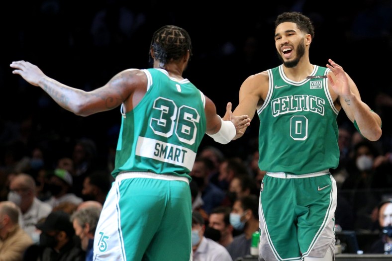 Feb 8, 2022; Brooklyn, New York, USA; Boston Celtics forward Jayson Tatum (0) high fives guard Marcus Smart (36) during the first quarter against the Brooklyn Nets at Barclays Center. Mandatory Credit: Brad Penner-USA TODAY Sports