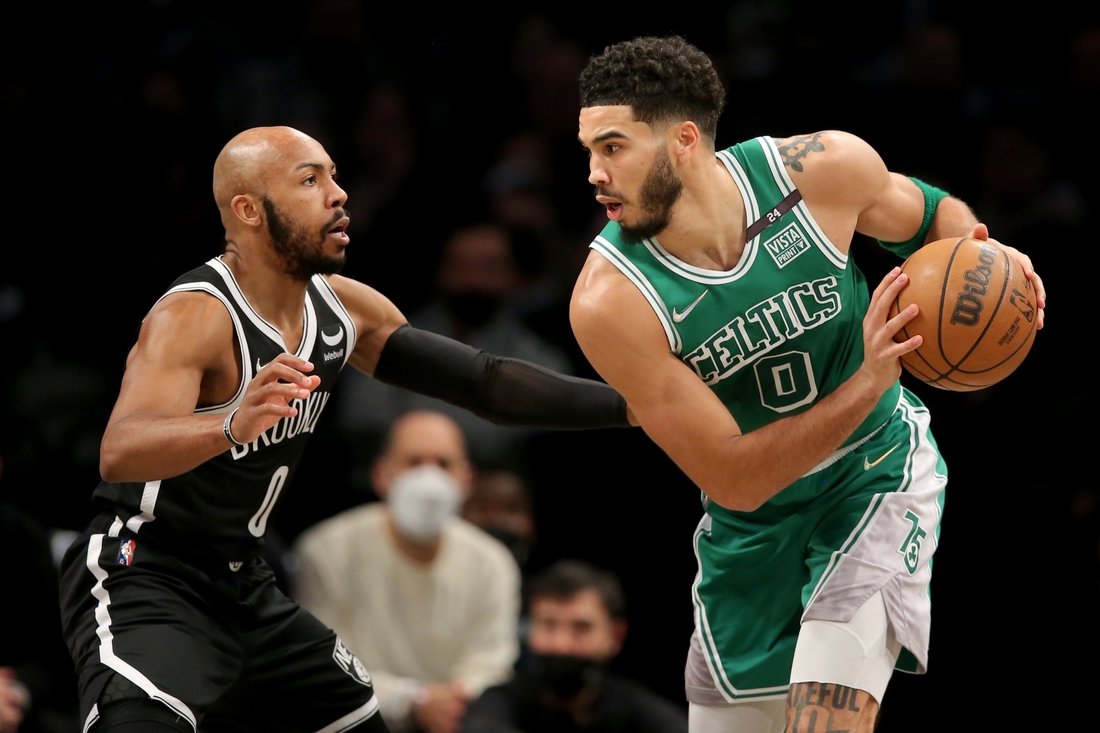 Feb 8, 2022; Brooklyn, New York, USA; Boston Celtics forward Jayson Tatum (0) controls the ball against Brooklyn Nets guard Jevon Carter (0) during the second quarter at Barclays Center. Mandatory Credit: Brad Penner-USA TODAY Sports