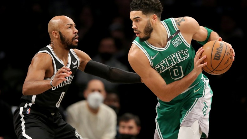 Feb 8, 2022; Brooklyn, New York, USA; Boston Celtics forward Jayson Tatum (0) controls the ball against Brooklyn Nets guard Jevon Carter (0) during the second quarter at Barclays Center. Mandatory Credit: Brad Penner-USA TODAY Sports