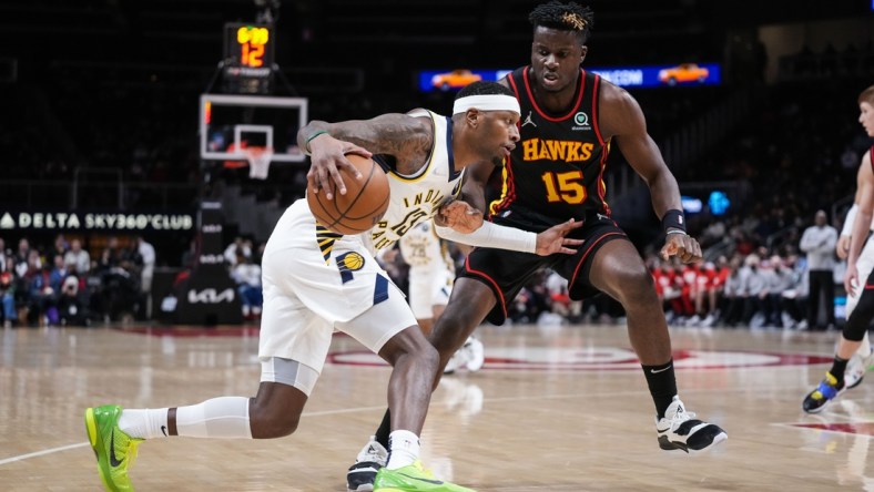 Feb 8, 2022; Atlanta, Georgia, USA; Indiana Pacers forward Torrey Craig (13) dribbles against Atlanta Hawks center Clint Capela (15) during the first half at State Farm Arena. Mandatory Credit: Dale Zanine-USA TODAY Sports